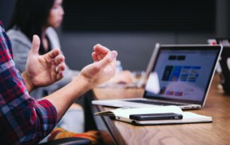 A team in an officer discussing relationship mapping software during a meeting 